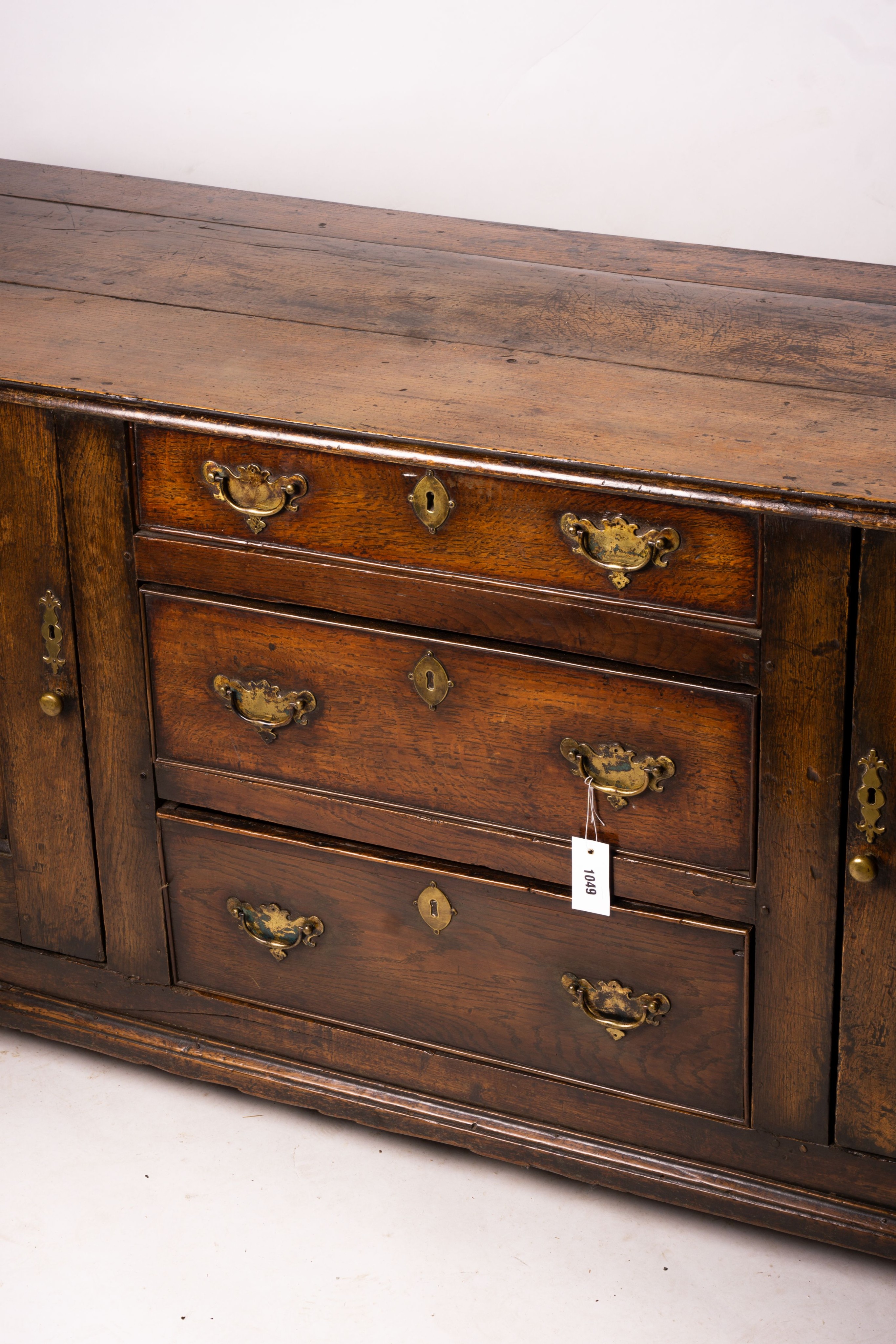 An 18th century oak low dresser base, length 191cm, depth 56cm, height 78cm